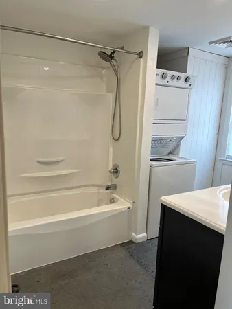 a bathroom with a bathtub and a shower