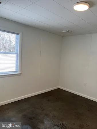 a view of a small space with wooden floor and a window