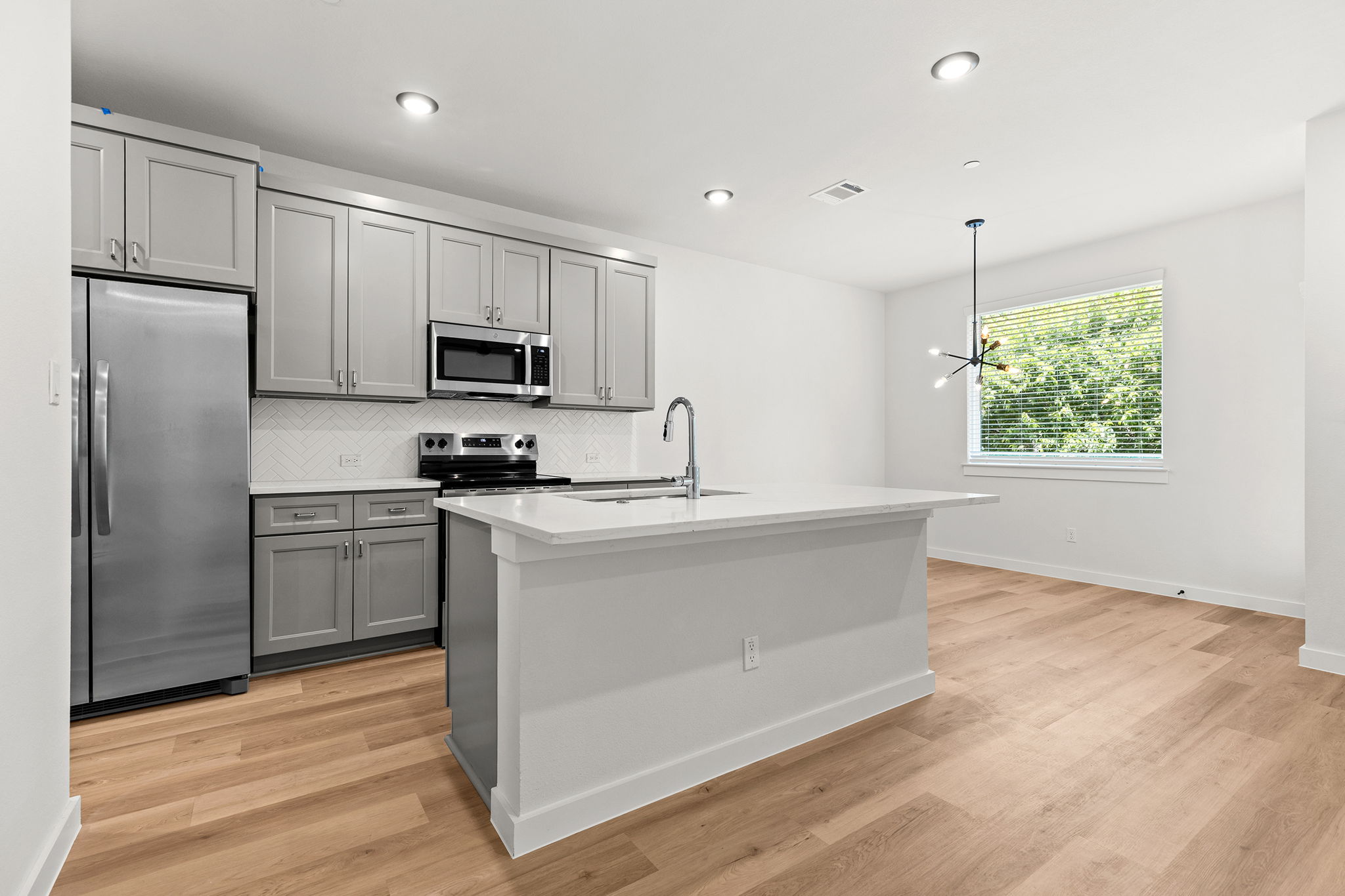 2600 Gattis School Road, Unit 1001 Round Rock, TX 78664 - Photo 9 of 40 Culinary dreams come alive in this well-appointed kitchen, featuring a spacious island and sleek modern appliances.