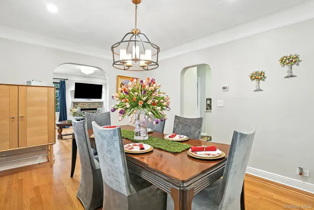 a view of a dining room with furniture wooden floor and chandelier