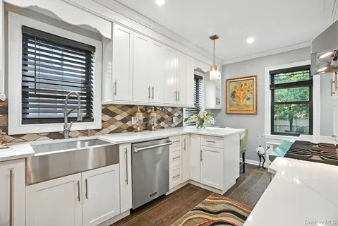 a kitchen that has a sink and a stove in it