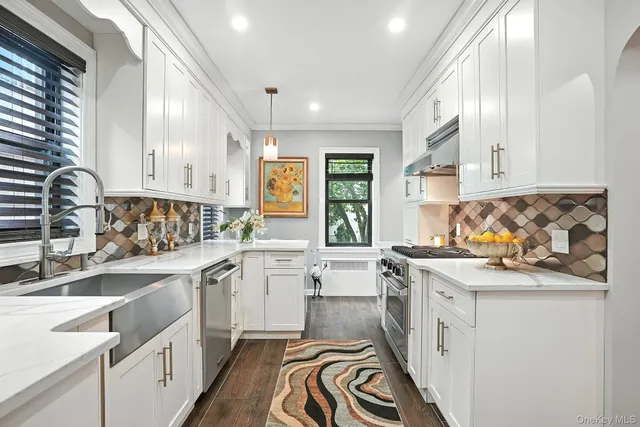 a kitchen with a sink stove and cabinets