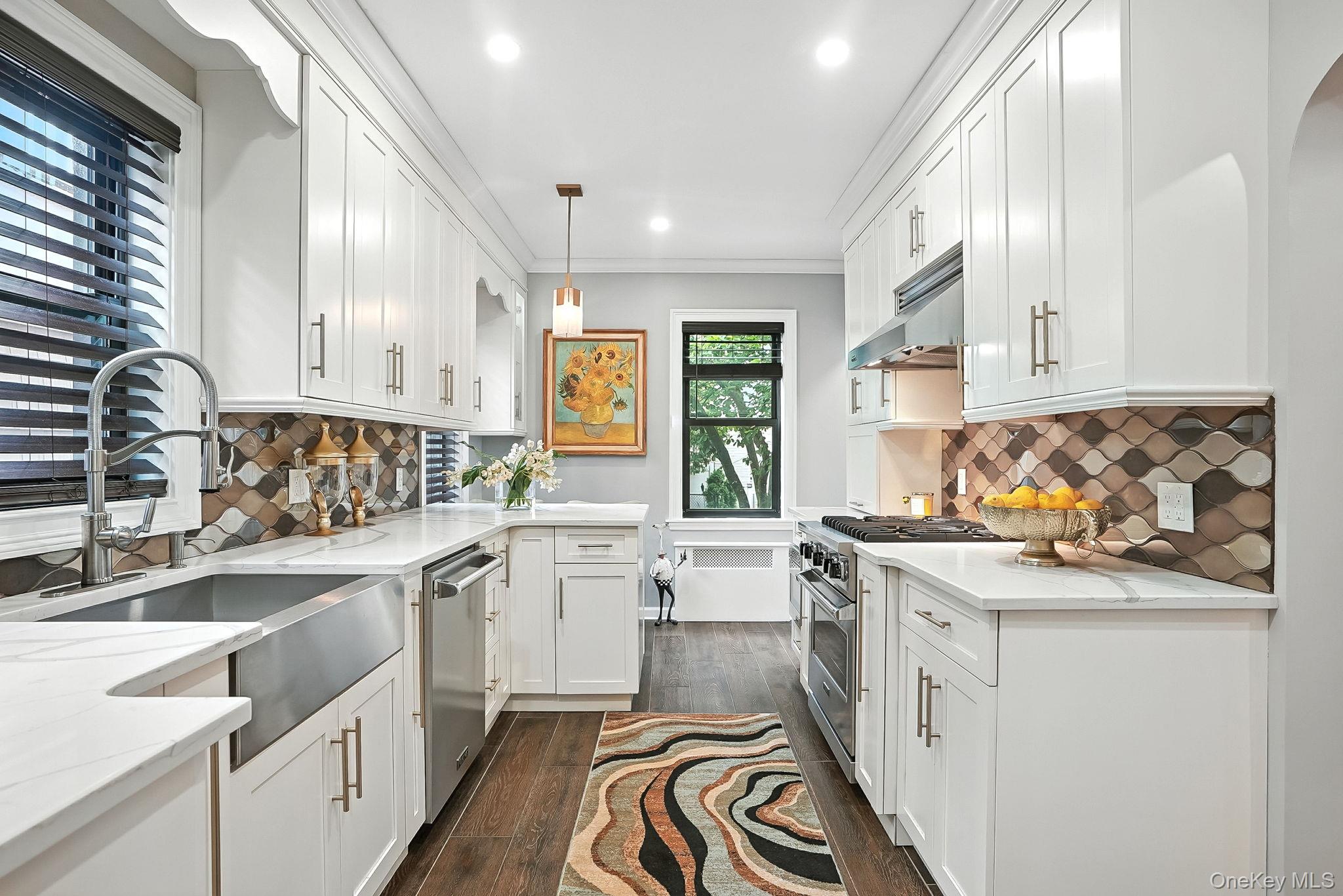 1260 Rhinelander Avenue Bronx, NY 10461 - Photo 17 of 50 Kitchen featuring light stone countertops, tasteful backsplash, white cabinets, recessed lighting, and ornamental molding
