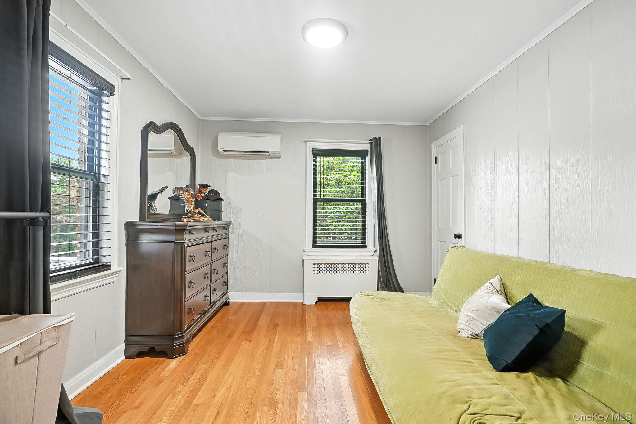 1260 Rhinelander Avenue Bronx, NY 10461 - Photo 22 of 50 Sitting room featuring ornamental molding, light wood-style flooring, radiator, and a wall mounted AC