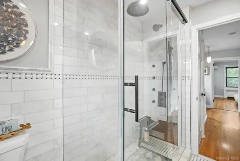 a bathroom with a glass shower door
