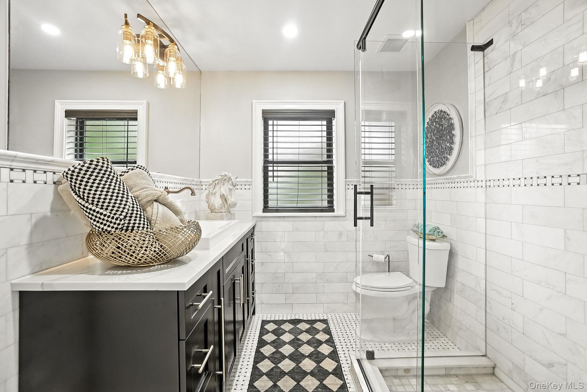 1260 Rhinelander Avenue Bronx, NY 10461 - Photo 24 of 50 Full bathroom featuring vanity, tile walls, a stall shower, a wainscoted wall, and recessed lighting