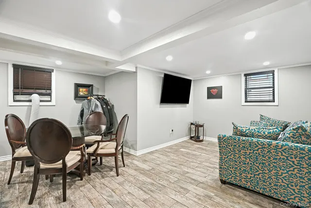 a living room with furniture a flat screen tv and a window
