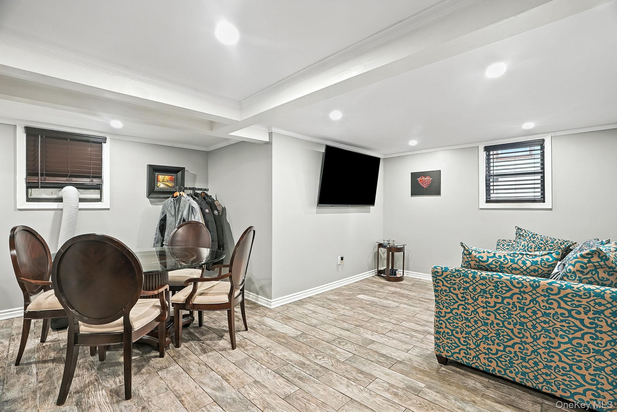 1260 Rhinelander Avenue Bronx, NY 10461 - Photo 30 of 50 Rec room featuring light wood finished floors, recessed lighting, and ornamental molding