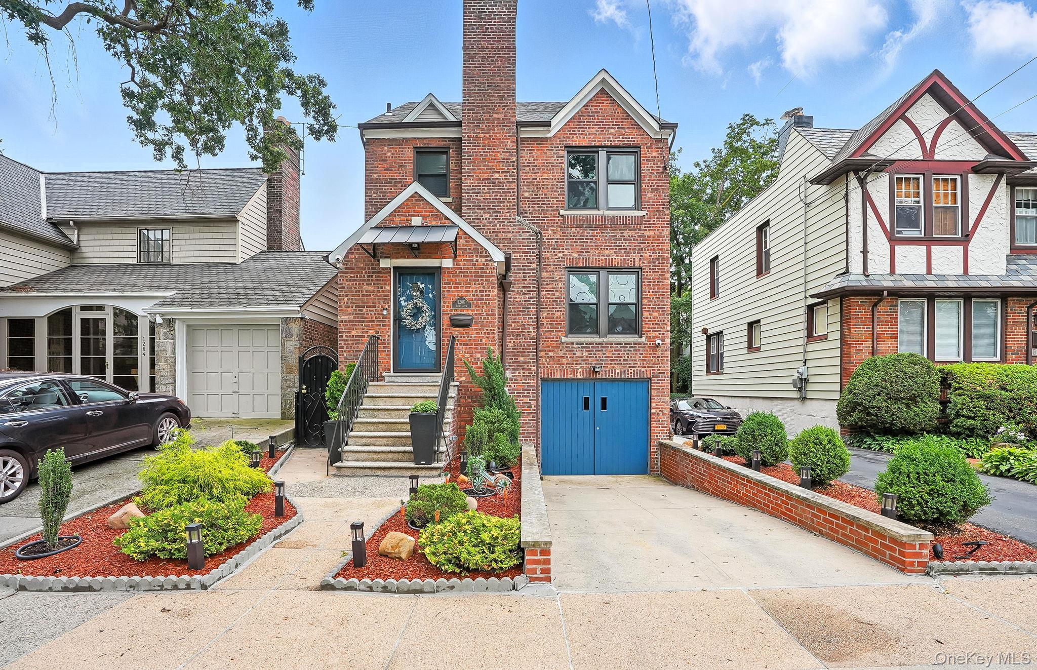 1260 Rhinelander Avenue Bronx, NY 10461 - Photo 3 of 50 English style home featuring brick siding, driveway, and a garage