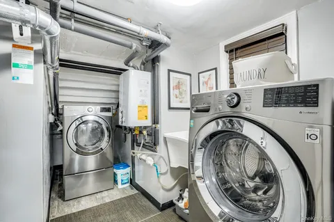 a utility room with sink dryer and washer