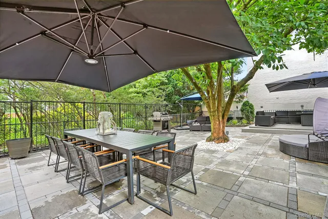a patio with a patio table and chairs