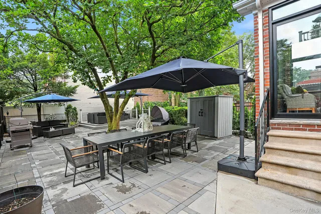 a view of backyard with outdoor seating and trees
