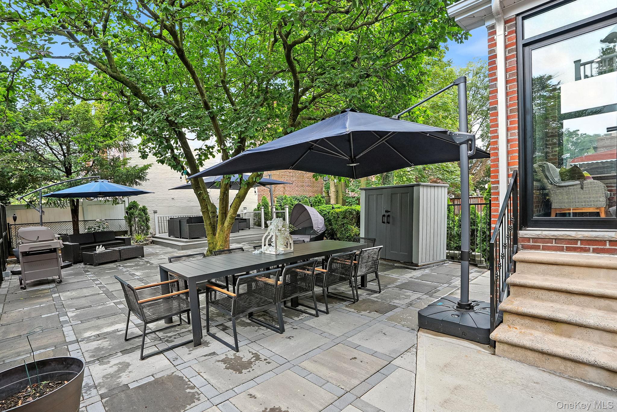 1260 Rhinelander Avenue Bronx, NY 10461 - Photo 37 of 50 View of patio featuring outdoor dining area, a storage unit, area for grilling, an outdoor hangout area, and a gazebo
