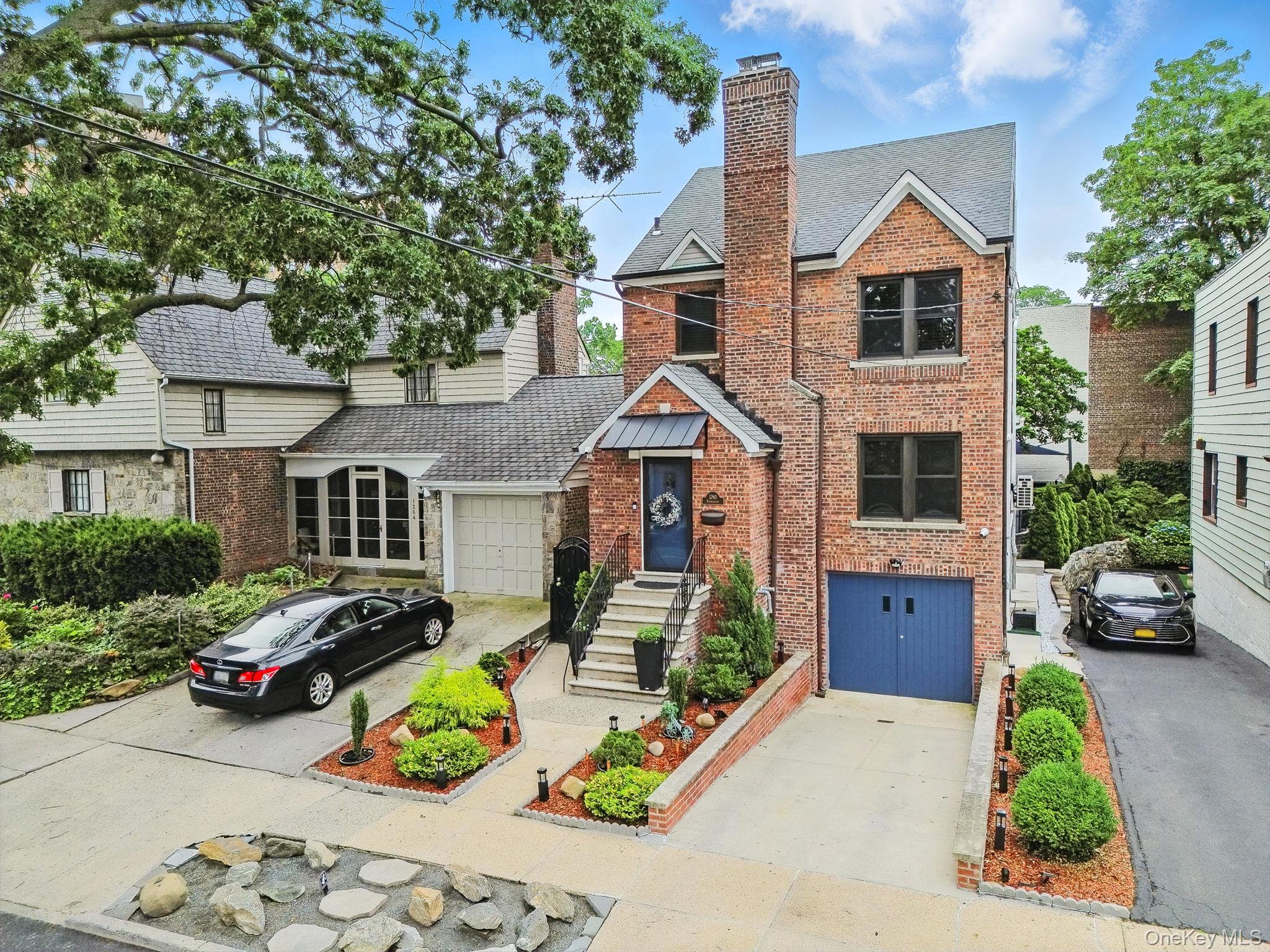 1260 Rhinelander Avenue Bronx, NY 10461 - Photo 42 of 50 View of front of property featuring brick siding, a chimney, and concrete driveway