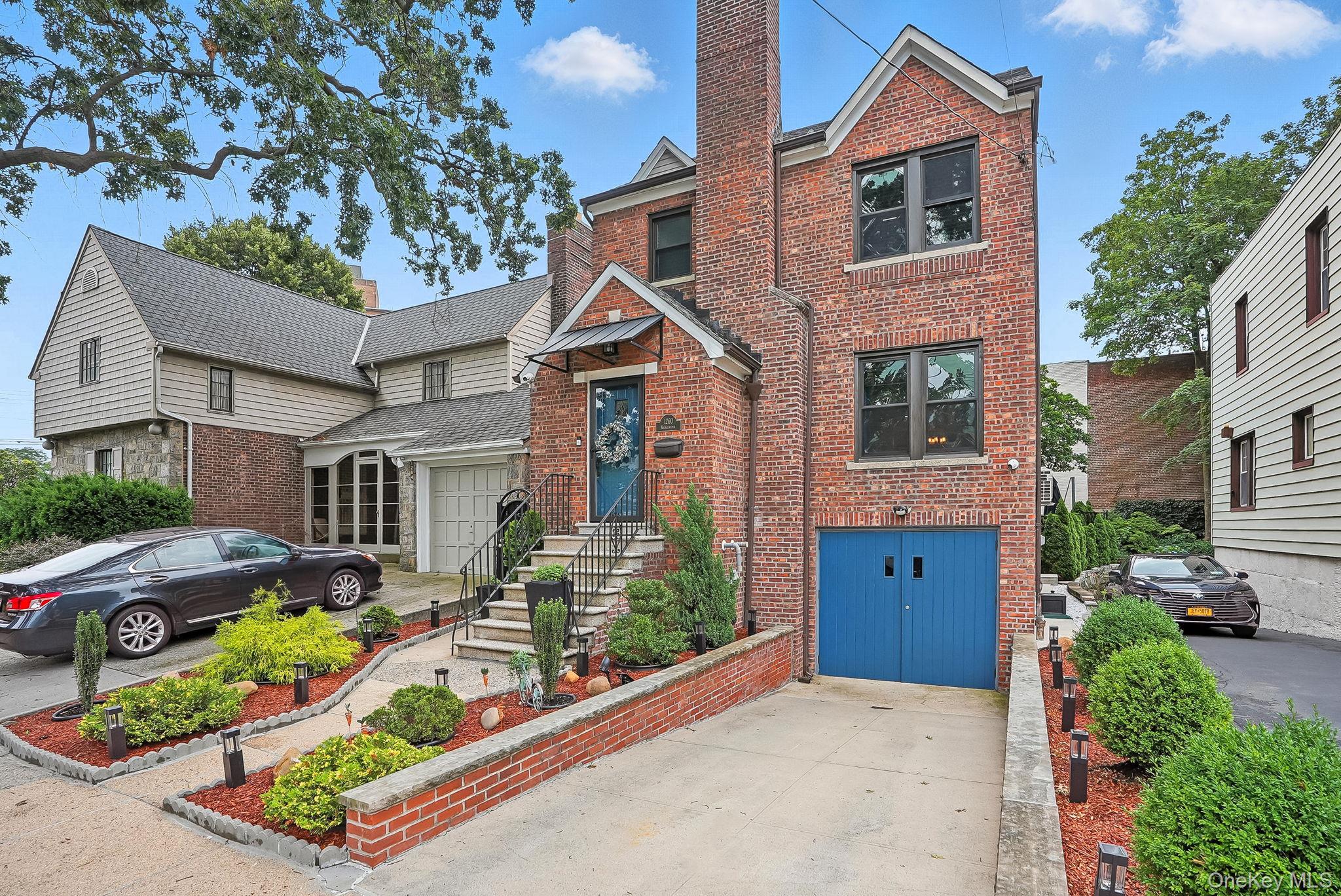 1260 Rhinelander Avenue Bronx, NY 10461 - Photo 46 of 50 Traditional-style house with a garage, brick siding, driveway, and a chimney