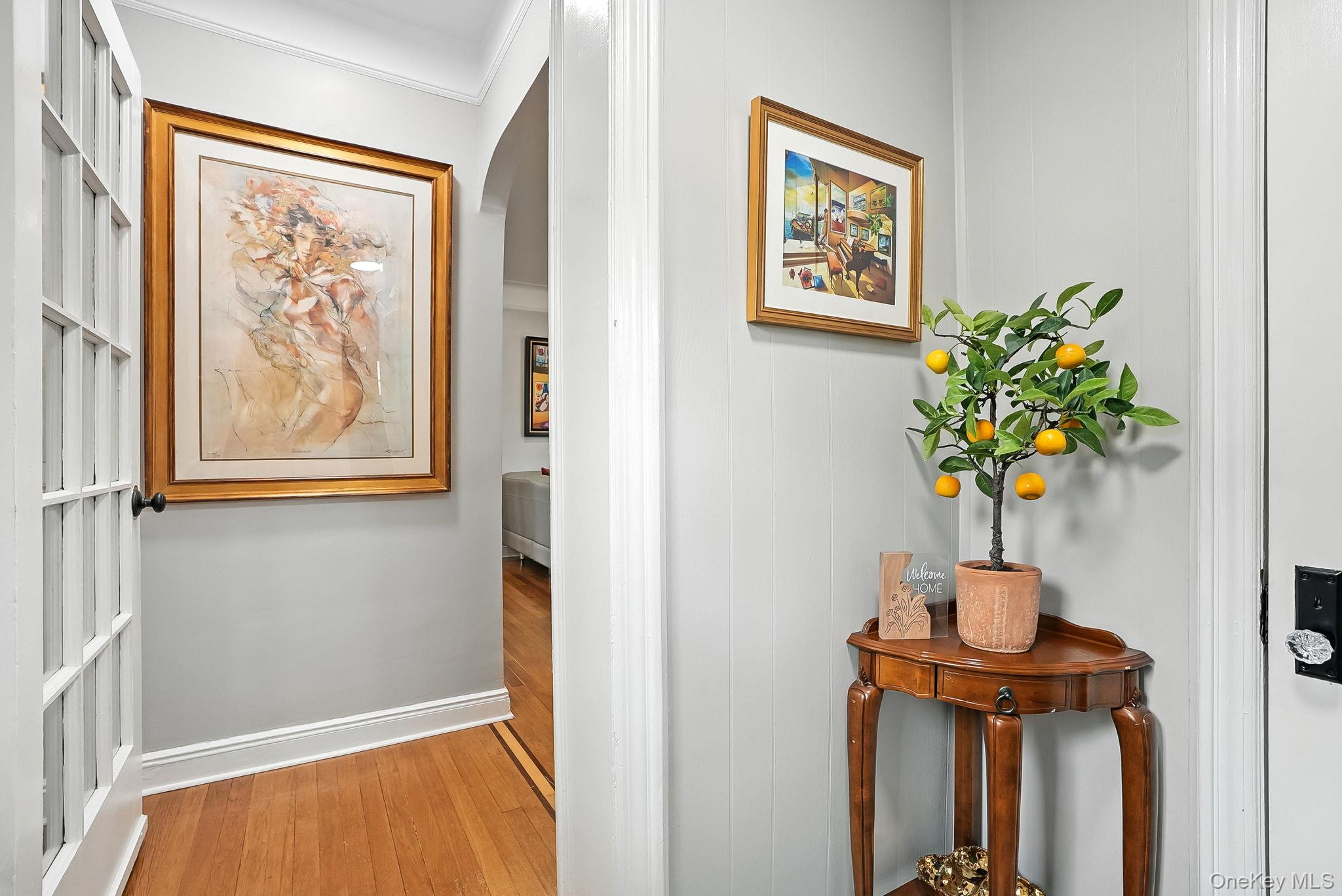 1260 Rhinelander Avenue Bronx, NY 10461 - Photo 6 of 50 Corridor with light wood-type flooring and ornamental molding