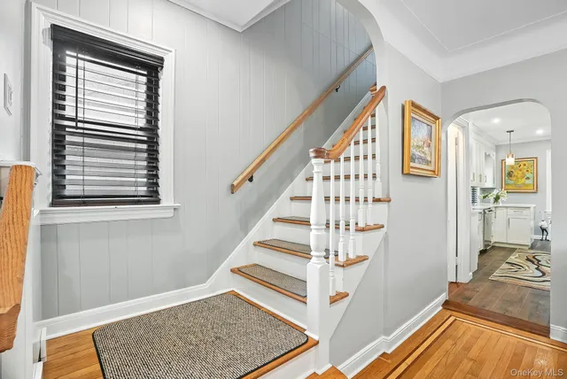 a view of entryway with wooden floor and livingroom