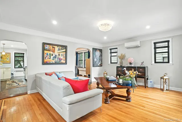 a living room with furniture and painting on the wall next to a window