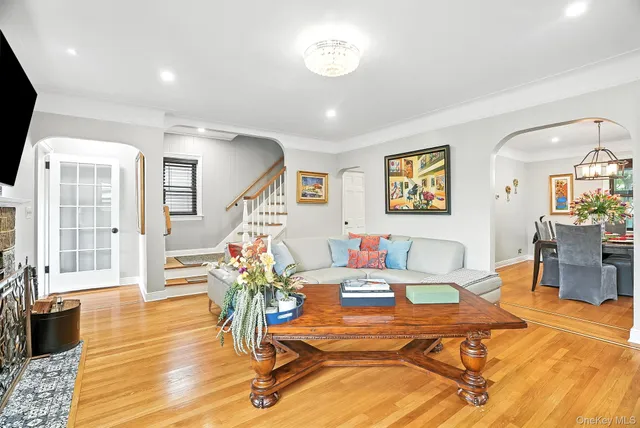a living room with dining room and wooden floor