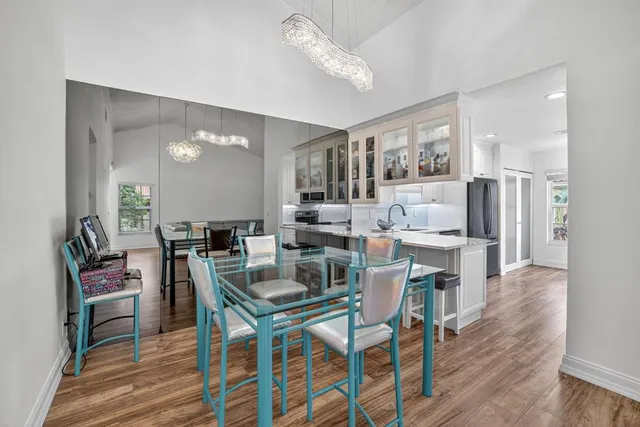 a view of a dining room with furniture wooden floor and chandelier