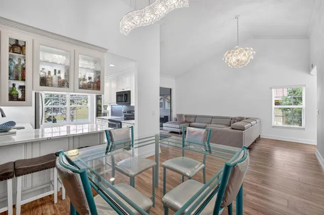 a kitchen with stainless steel appliances granite countertop a refrigerator a stove a sink and a microwave