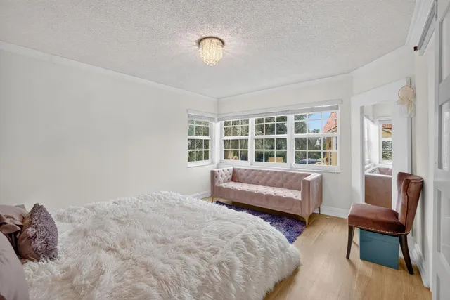 a bedroom with a bed and a chandelier