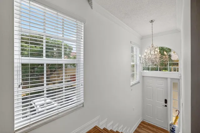 an aerial view of residential houses with outdoor space and lake view