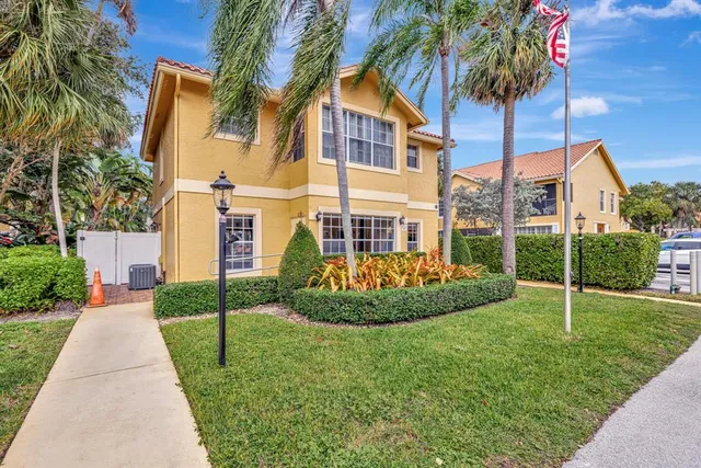an aerial view of lake and residential houses with outdoor space