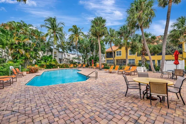 an aerial view of a house with a yard and large trees