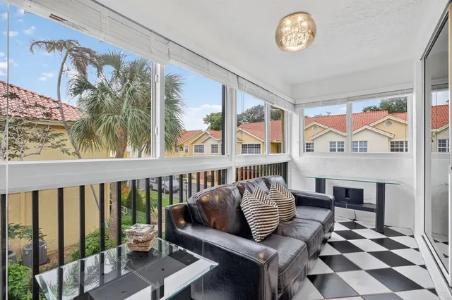 a bedroom with furniture and a large window