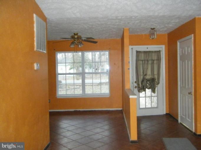 987 Crystal Rock Road Lusby, MD 20657 - Photo 4 of 14 a view of an empty room with a window