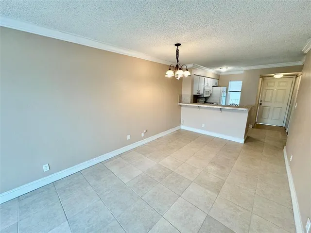 a view of a kitchen with a white cabinets