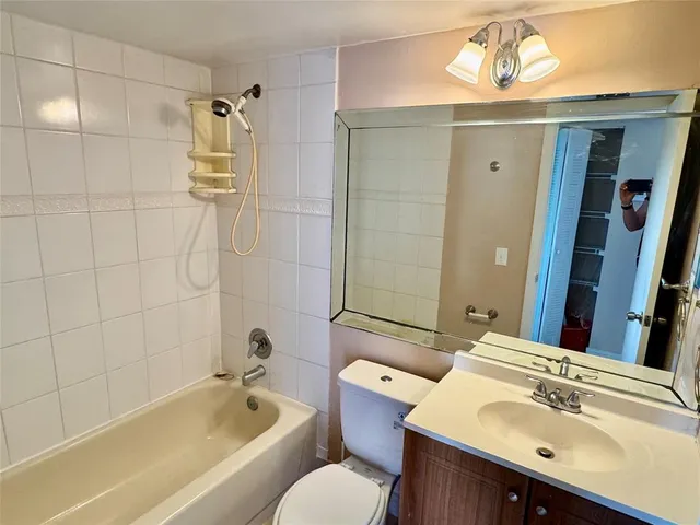 a bathroom with a sink mirror toilet and bathtub