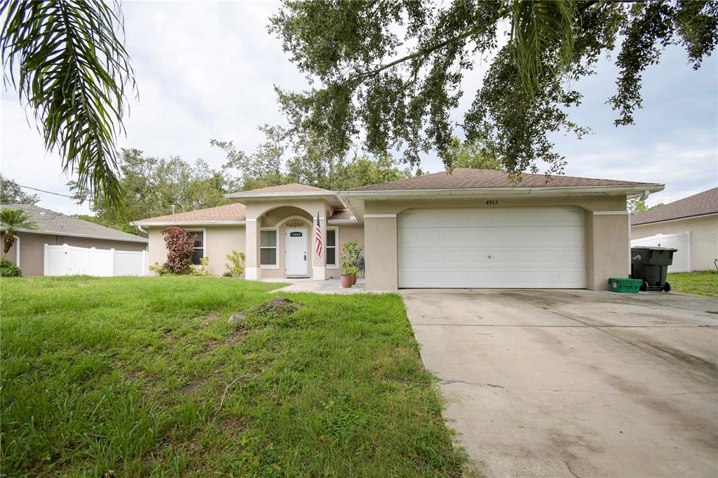 4913 Cromey Road North Port, FL 34288 - Photo 1 of 36 a front view of a house with yard and tress