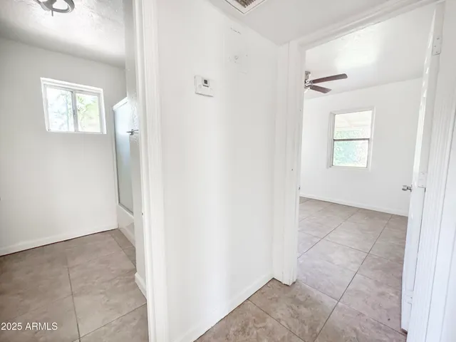 a view of a room with window and a ceiling fan
