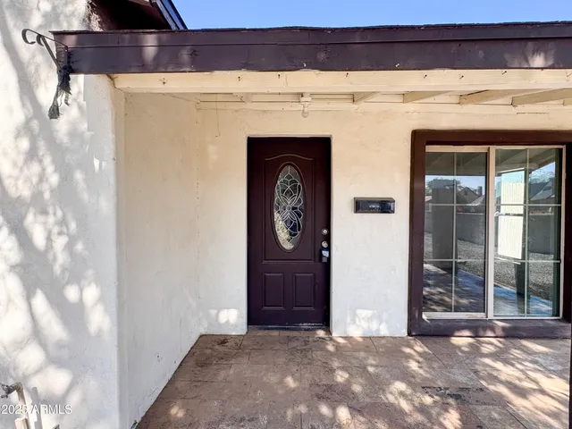 a view of a house with a tree and garage