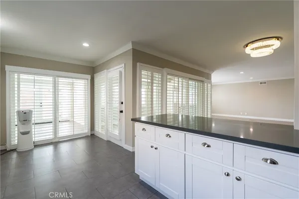 a large kitchen with stainless steel appliances a refrigerator and a stove