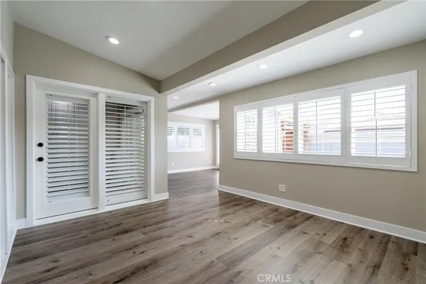 a view of wooden floor and windows in a room