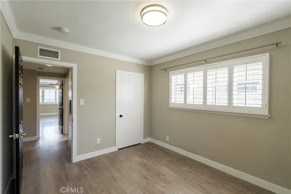 a bathroom with a sink a toilet a window and shower