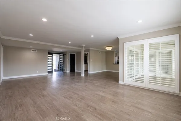 a view of a kitchen with a stove wooden floor and a window