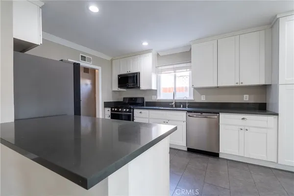 a kitchen with stainless steel appliances a refrigerator sink and cabinets