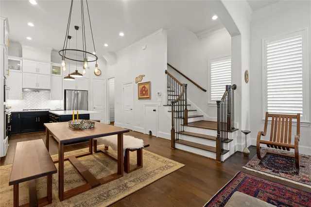 a living room with a flat screen tv and a hard wood floor