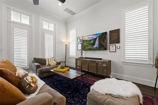 a living room with furniture ceiling fan and a rug