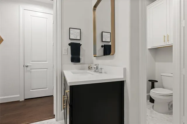 a bathroom with a sink toilet and a mirror