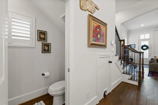 a living room with stainless steel appliances furniture a rug and a window