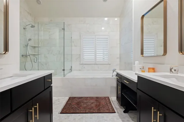 a bathroom with a tub sink and mirror