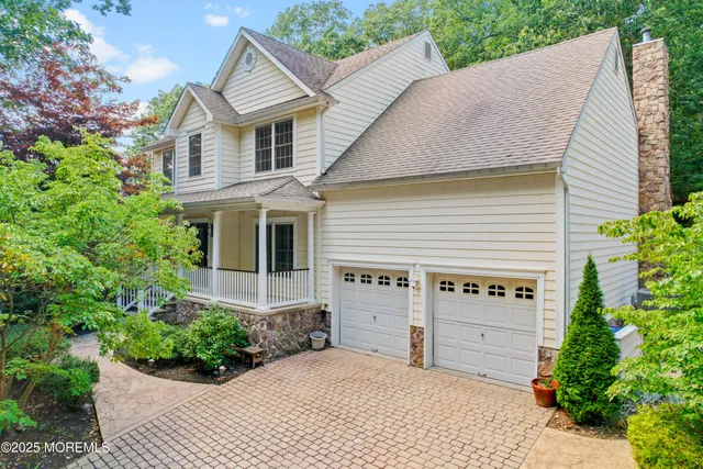 a view of a house with a yard and potted plants