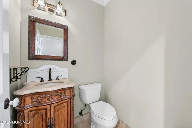a bathroom with a toilet a sink and mirror