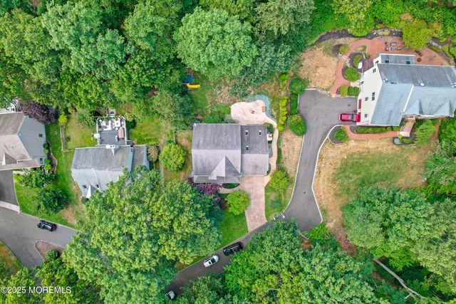 an aerial view of residential house with outdoor space and swimming pool