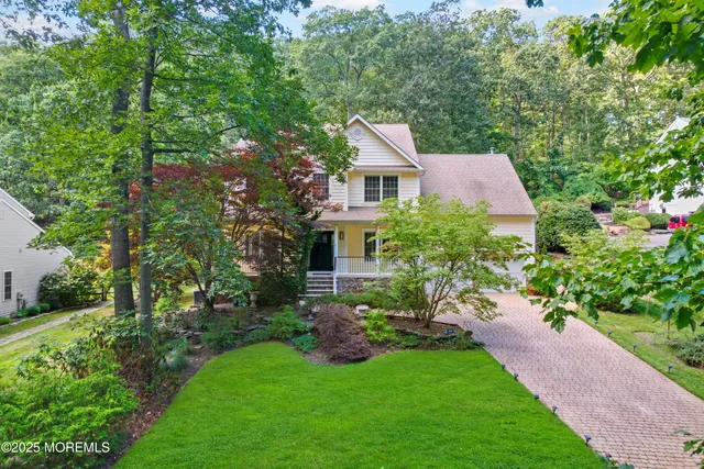 a aerial view of a house with a big yard plants and large trees